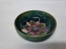 A MOORCROFT POTTERY COLUMBINE PATTERN BOWL, the footed bowl tube lined with a dark pink columbine