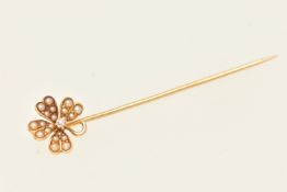 A YELLOW METAL STICK PIN, a floral stick pin set with seed pearls and an old cut diamond,