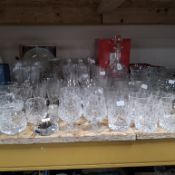 A COLLECTION OF MOSTLY CRYSTAL CUT GLASSWARE comprising a group of whisky tumblers, wine glasses,