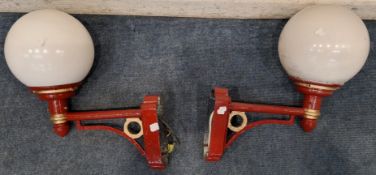 A PAIR OF RED AND GOLD PAINTED CAST ALUMINIUM WALL LIGHTS, with spherical shades Dimensions: