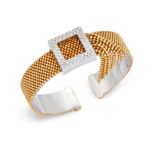 A diamond torque bangle, with brilliant-cut diamond buckle form panel with bead-link chain tassel...