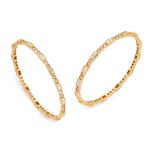 A pair of diamond set bangles, designed as pairs of channel-set carré-cut diamonds, alternating w...