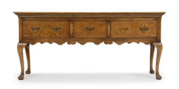 An English oak dresser base, of George III style, last quarter 20th century, with three drawers a...
