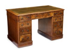 A Victorian walnut pedestal desk, third quarter 19th century, the top inset with tooled leather w...
