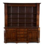 A George III mahogany crossbanded oak dresser, third quarter 18th century, the plate rack with in...
