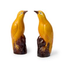 A pair of Chinese yellow-glazed models of birds Republic period Each bird modelled standing on ...