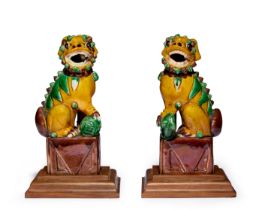 A pair of Chinese sancai-glazed Buddhist lions Late Qing dynasty Each modelled seated on a rect...