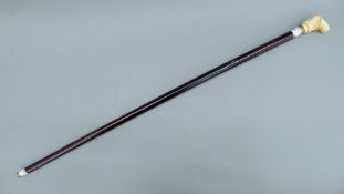 A bone-handled walking stick, the handle carved as a gentleman. 91.5 cm long.
