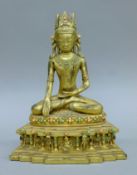 A gilt bronze figure of Buddha seated. 23 cm high.