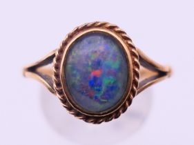 A 9 ct gold and black opal ring. Ring size T. 3.4 grammes total weight.