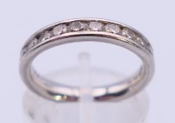 A platinum and diamond half eternity ring. Ring size k. 5.6 grammes total weight.