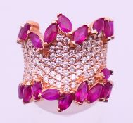 A Modernist 14ct gold, ruby and diamond ring. Ring size I/J.