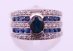 A 9 ct white gold, sapphire and diamond ring. Ring size K/L. 4 grammes total weight.