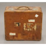 A vintage leather suitcase with some old travel labels. 55 cm wide.