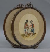 A pair of 19th century watercolours of soldiers, housed in carved oak frames. Each 32 cm high.
