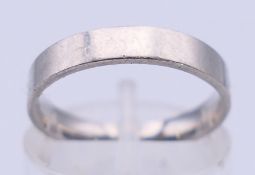 A platinum wedding band. Ring size K. 3.8 grammes.