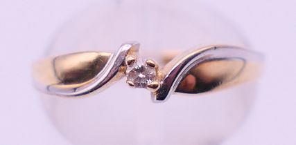 A 10 ct bi-colour gold diamond solitaire ring. Ring size N. 1.6 grammes total weight.