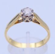 An 18 ct gold and diamond solitaire ring. Ring size R/S.