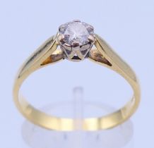 An 18 ct gold and diamond solitaire ring. Ring size R/S.