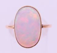 A 9 ct gold and opal ring. Ring size R/S. 3.3 grammes total weight.