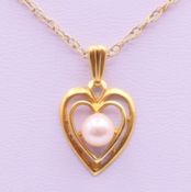 A 9 ct gold and pearl heart pendant on a 9 K gold chain. Pendant 1.