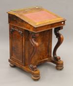 A Victorian burr walnut Davenport, the top with inset presentation inscription. 55 cm wide.