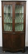 An early 20th century glazed mahogany corner cabinet. 87 cm wide x 183 cm high.