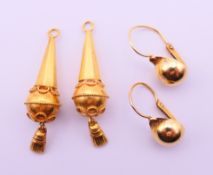 Two pairs of unmarked gold earrings. 3.5 cm high and 1 cm diameter respectively. 4.9 grammes.