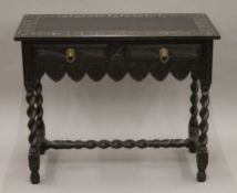 A Victorian carved oak two-drawer side table. 91 cm wide x 75 cm high x 44 cm deep.