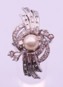An 18 ct white gold, diamond and pearl ring. Ring size T.