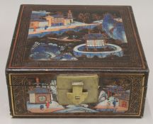 A 19th century Chinese lacquered document box painted with figures and a sampan. 28 cm square.