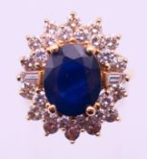 A 14ct gold, diamond and sapphire cluster ring. Ring size N/O.