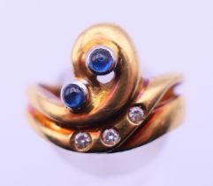 A contemporary 18 ct gold, diamond and sapphire ring. Ring size P/Q. 7.6 grammes total weight.