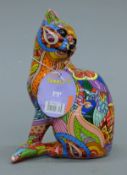 A graffiti-decorated model of a cat. 14 cm high.