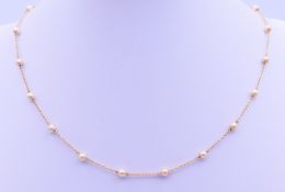 A 9 ct gold and seed pearl necklace. 36 cm long 2.9 grammes total weight.