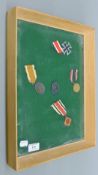 A frame containing German military medals. 31 x 41.5 cm.