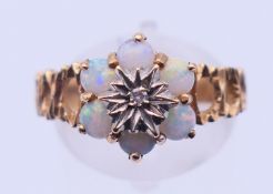 A 9 ct gold, diamond and opal ring. Ring size P/Q. 3.3 grammes.