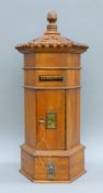 A wooden letter box. 56.5 cm high.