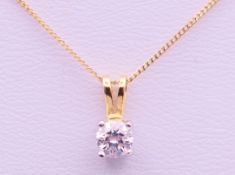 A diamond set gold pendant on an 18 ct gold chain.
