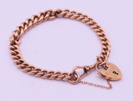 A 9 ct gold bracelet with padlock fastening. 19 cm long. 27.5 grammes.
