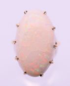 A 9 ct gold white opal cabochon set ring. Opal setting 2.5 x 1.5 cm. Ring size N/O.
