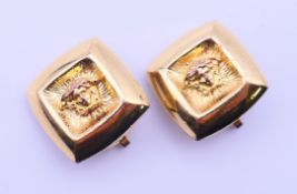 A pair of Gianni Versace Medusa clip-on earrings. 1.75 x 1.75 cm.