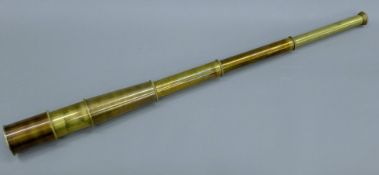 A brass four-drawer extendible telescope. 91 cm long extended.