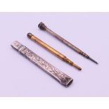Two propelling pencils and a silver cased pencil. The latter 8 cm long.