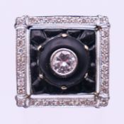 A white gold, diamond and onyx ring. Ring size L.