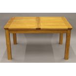A modern oak single leaf extending dining table.