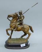 A cast resin and metal model of a cavalry man on horseback. 37 cm high overall.