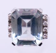A 14 K white gold, diamond and aquamarine ring. Ring size O/P. 7.9 grammes total weight.