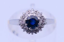 An 18 ct gold and platinum diamond and sapphire ring. Ring size M. 2.4 grammes total weight.