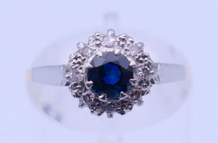 An 18 ct gold and platinum diamond and sapphire ring. Ring size M. 2.4 grammes total weight.